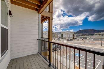 Balcony with view of parking lot and mountains